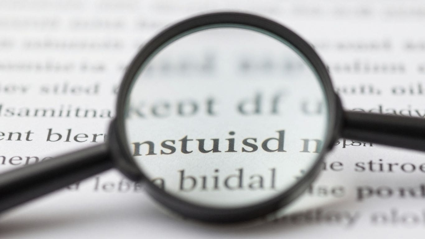 magnifying glass enlarging text on paper